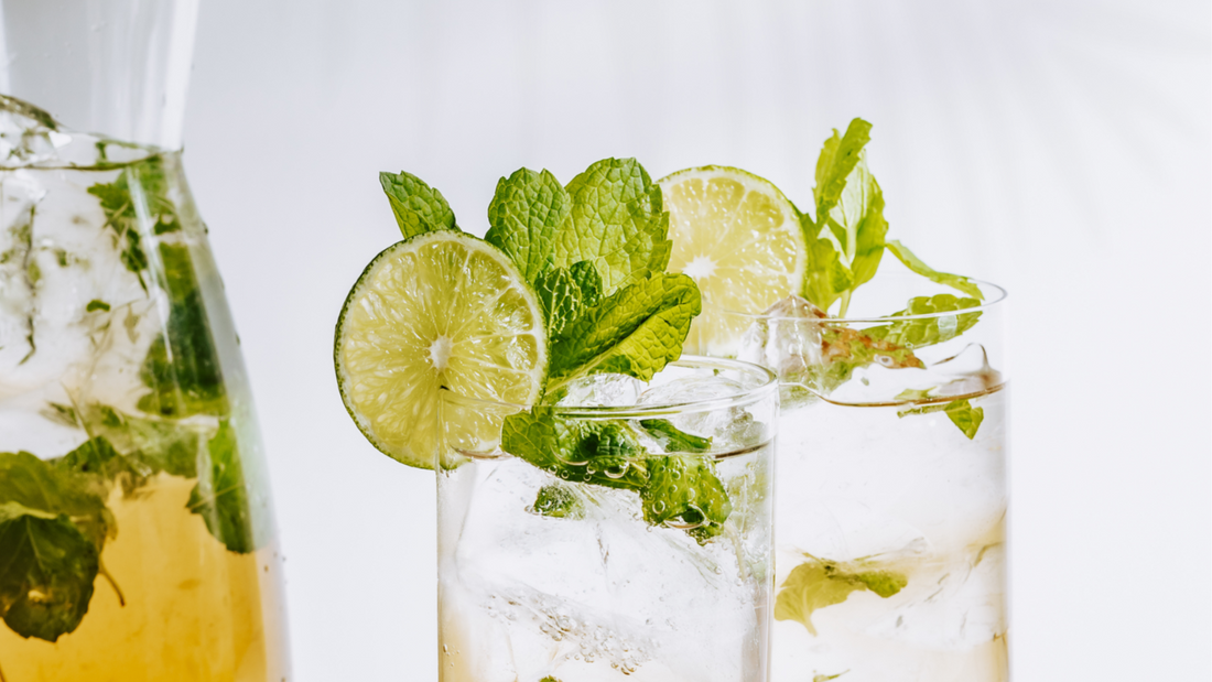 Spiced Rum Mojito – the Mijita – by Candela Mamajuana Spiced Rum. Recipe image shows cocktail prepared with fresh mint and limes and as a batch cocktail in a pitcher.