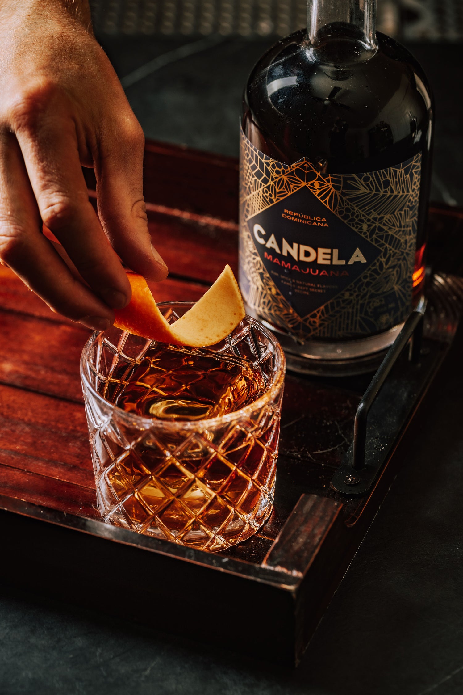 Candela presented in it's signature serve: on the rocks with an orange twist.
